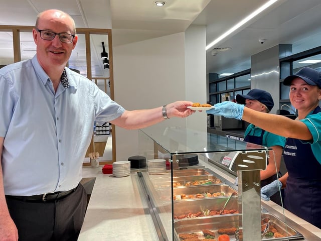 A Crossroads restaurant staff member serves up lunch to Western Trust Chief Executive Neil Guckian.