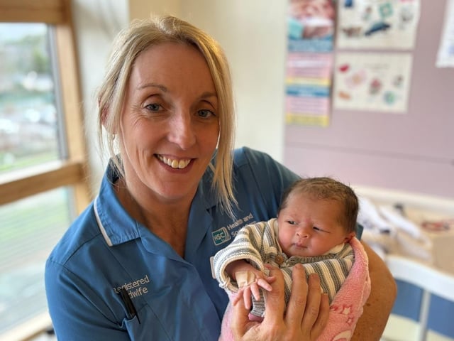 Midwife Jenni with baby daughter of Leanne from Newtownstewart born on New Year's Eve at 11:49 weighing 6lb 6oz.