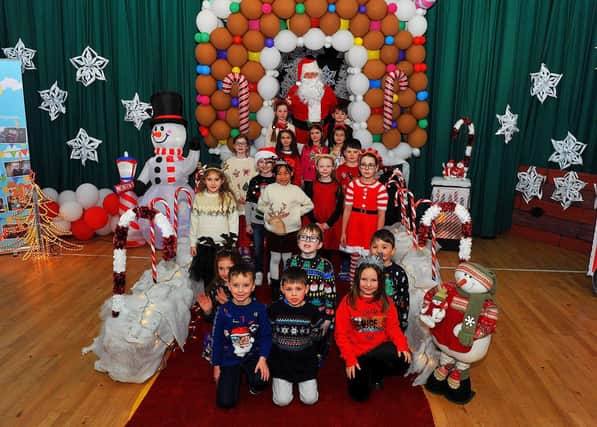 Mrs Spence’s P3 class pictured with Santa during his visit to St Eithne’s Primary School on Friday. Photo: George Sweeney. DER2250GS – 46