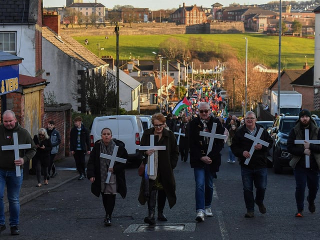 Relatives carry white crosses during the annual Bloody Sunday march. Photo: George Sweeney