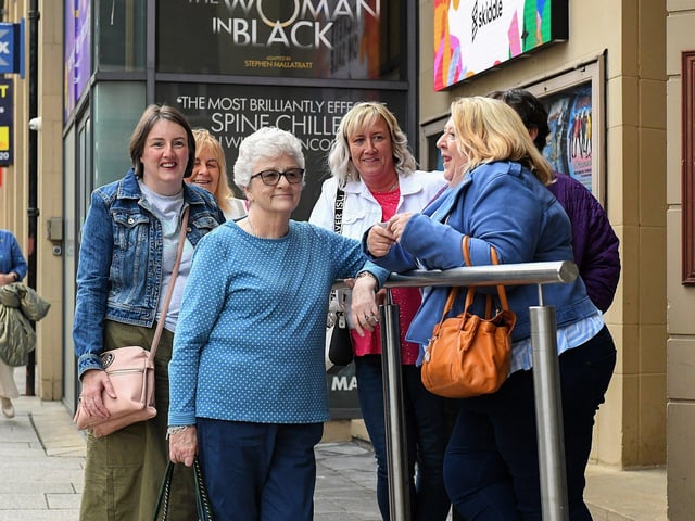 Spectators watch the Jaydee Brass Band performance outside the Millennium Forum on Friday evening. Photo: George Sweeney