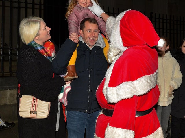 Santa greeting children at the Derry Christmas Lights parade in 2021. Photo: George Sweeney. DER2147GS – 014