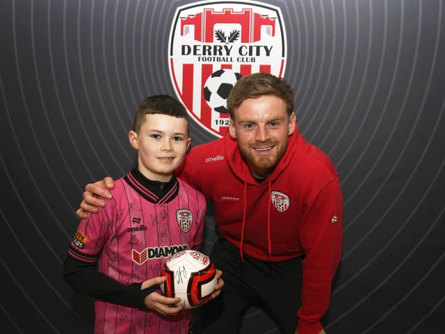 Candystripes fan Matthew Higgins pictured with Derry City's Rob Slevin at the club's merchandise store in Foyleside Shopping Centre. Photo: George Sweeney