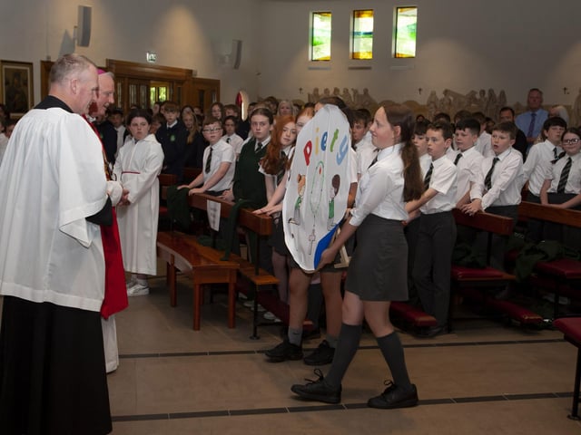 Children bringing forward their artwork during last week’s Confirmation Thanksgiving Mass.