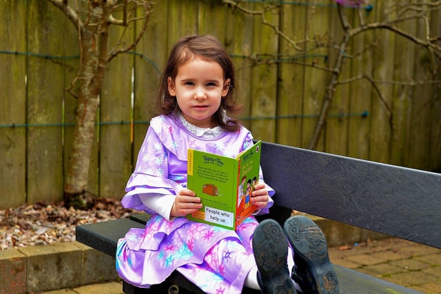 Emily reads one of her favourite books on World Book Day at Belmont Nursery School on Racecourse Road. Photo: George Sweeney. DER2310GS – 27