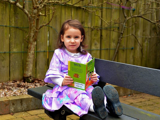 Emily reads one of her favourite books on World Book Day at Belmont Nursery School on Racecourse Road. Photo: George Sweeney. DER2310GS – 27