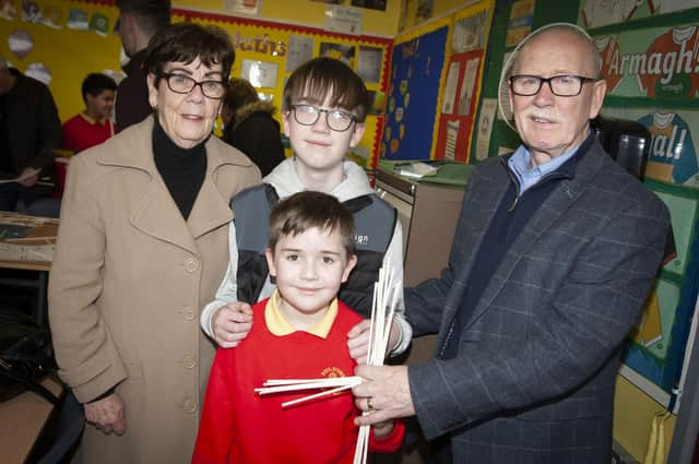 Steelstown pupil Eoin pictured with his big brother and granny and granda Morrison.
