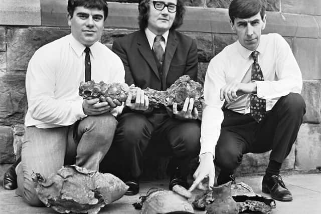 1971... City of Derry Sub-Aqua Club members Archie Jack (left) and Pat Stewart (right), who located the wreck of the Spanish Armada, pictured with Dr. Keith Lindley, lecturer in history at Magee University, who is holding a swivel-type gun recovered from the wreck.