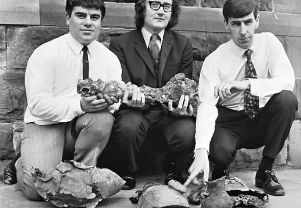 1971... City of Derry Sub-Aqua Club members Archie Jack (left) and Pat Stewart (right), who located the wreck of the Spanish Armada, pictured with Dr. Keith Lindley, lecturer in history at Magee University, who is holding a swivel-type gun recovered from the wreck.