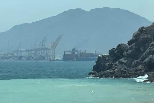 This frame grab taken from AFPTV video footage on July 12, 2026 shows a ship sailing near the Strait of Hormuz off the eastern coast of the United Arab Emirates at Khor Fakkan. (Photo by AFPTV / AFP via Getty Images).