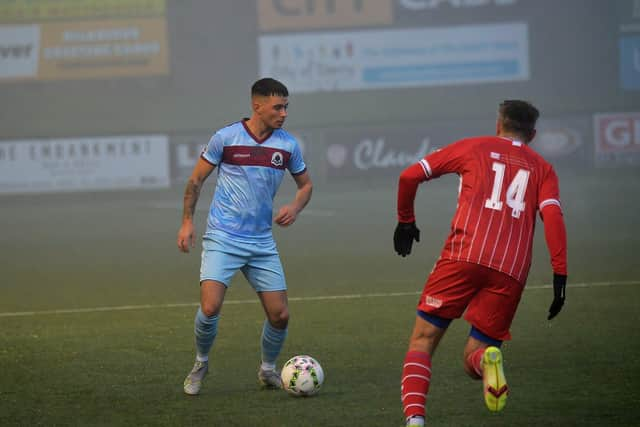 Institute defender Rhys McDermott surveys his option against Loughgall.