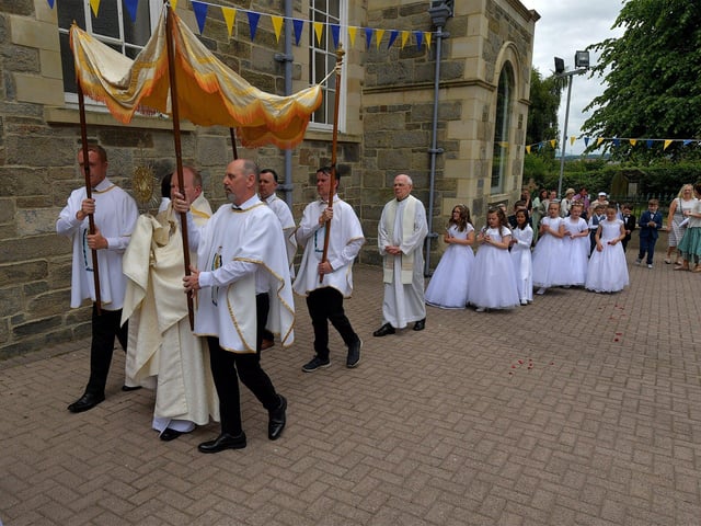 Fr. Gerard Mongan, administrator of St Columba’s Church, Long Tower, carries the Blessed Sacrament at the Solemnity of Corpus Christi procession, in the ground of the church on Sunday afternoon. Photo: George Sweeney. DER2324GS –