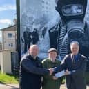 L-R Bogside Artists Kevin Hasson and Tom Kelly receiving a grant from Martin Galvin on behalf of the AOH in the US.