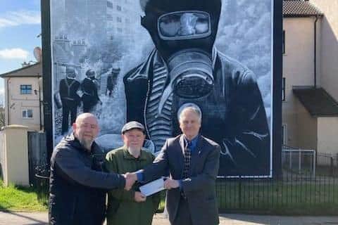 L-R Bogside Artists Kevin Hasson and Tom Kelly receiving a grant from Martin Galvin on behalf of the AOH in the US.