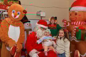 Ellie and Kelsey pictured with Santa and his helpers at the Galliagh Community Christmas Craft Fair and Wonderland on Saturday afternoon.  Photo: George Sweeney