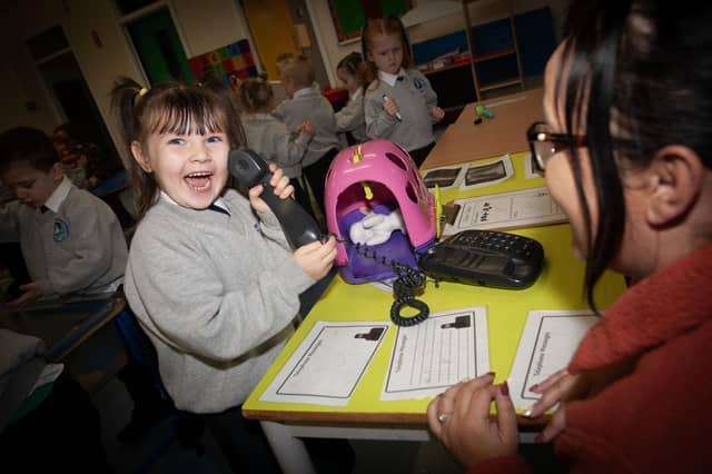 Hi Mum! It's Orlaith. . . .P1 pupil Orlaith at Sacred Heart calls home during play on Thursday last. (Photos: Jim McCafferty Photography)
