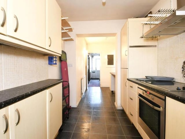 This is another shot of the kitchen. Although it is narrow, there is much more room available than you think.,