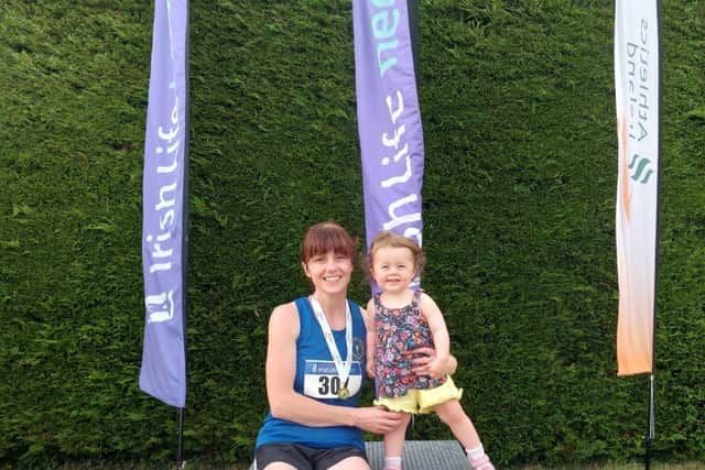 Olympian’s new All Ireland Masters F40 100m champion, Karen O’Donnell, celebrates with her daughter.