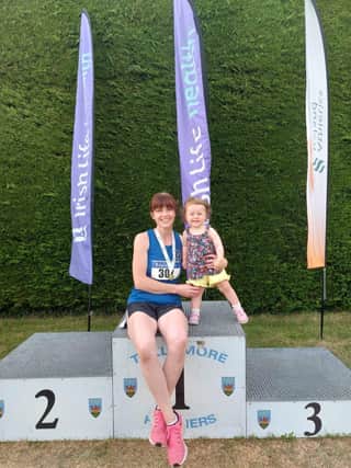 Olympian’s new All Ireland Masters F40 100m champion, Karen O’Donnell, celebrates with her daughter.