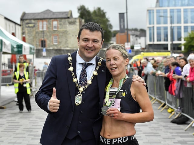Claire McGuigan, Strabane AC, first female to complete the 2025 Waterside Half Marathon pictured with Mayor Ruairí McHugh . Photo: George Sweeney