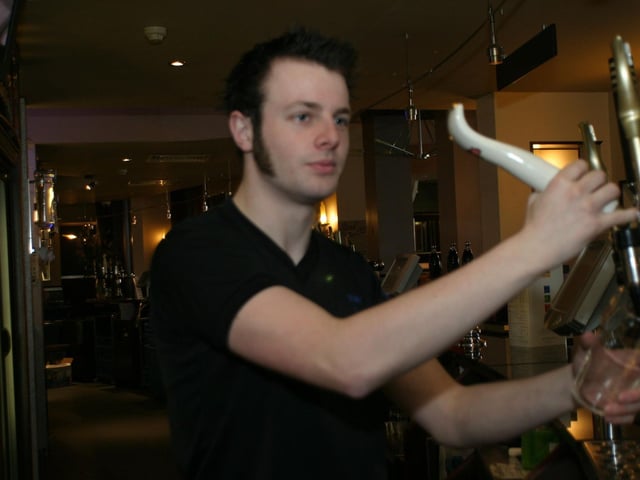Ronan McCormick pulls a pint for one of the regulars at Ice Wharf in June 2004.