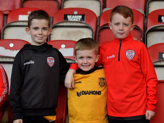 Derry City fans Dylan and Jack Doherty alongside Luca Hawkins (right) at Friday night's game against St Patrick’s Athletic. DER2317GS-77