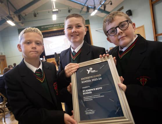 Proudly holding the Enterprising Schools 2023-24 Young Enterprise award are Year 8 students Charlie Carton, Noah Doran and Charlie Divin.