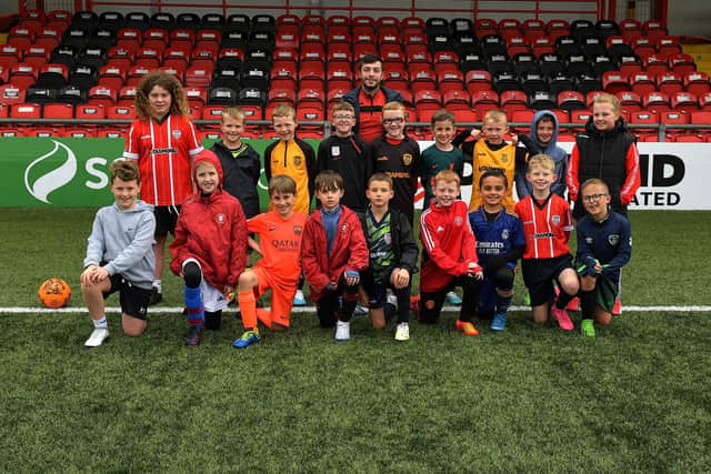 Children pictured at the launch of the Ryan McBride 2023 Summer Camp, at the Brandywell Stadium, with Foundation coach Aaron Rogan. Photo: George Sweeney. DER2327GS - 004