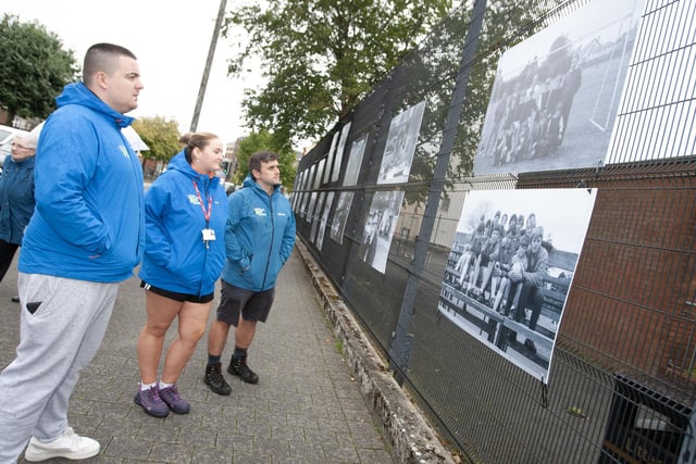 Members of the North West Youth Services take some time to look over the photo exhibition at Pilot's Row on Friday evening.