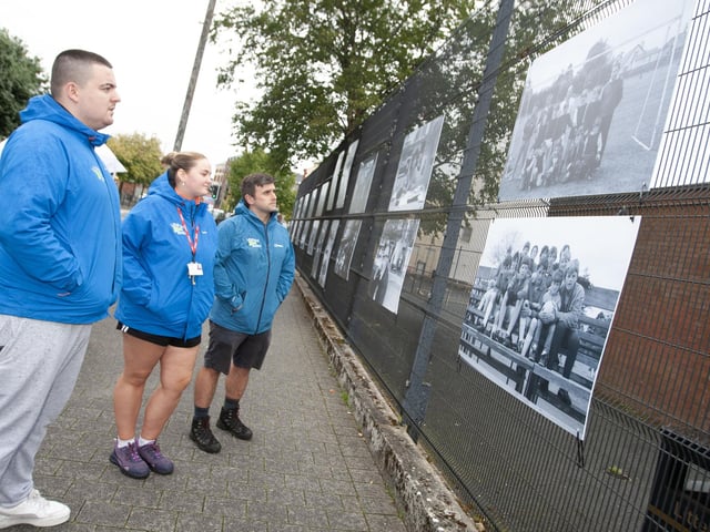 Members of the North West Youth Services take some time to look over the photo exhibition at Pilot's Row on Friday evening.