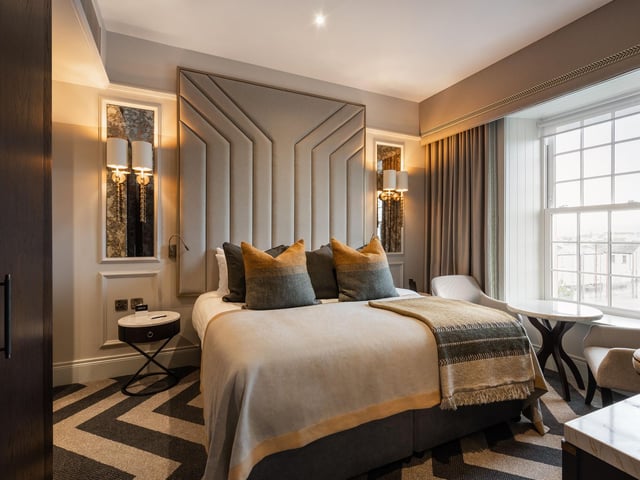 A room in the Ebrington Hotel Clock Tower building with a river view.