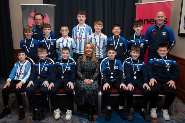 Caroline Casey, manager, O’Neills Sports Superstore, Derry pictured with Strabane AFC, League runners-up 2010, at the Annual Awards in the City Hotel on Friday night last. Included are coaches Marty McDaid and Scaldy Roulston. (Photo: Jim McCafferty)