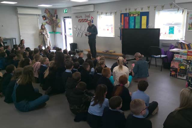 Principal Fiachra Ó Donghaile addressing pupils at Gaelscoil na Daróige as the school welcomed Máire Zepf to Ballymagroarty.