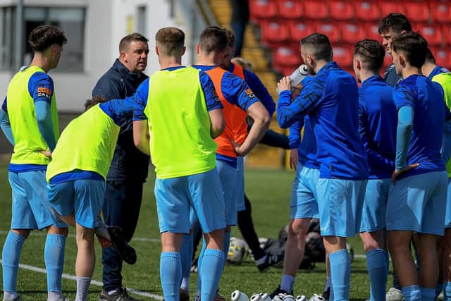 Institute coach Mo Mahon speaking to players during the pre-match warm-up. Photograph: George Sweeney