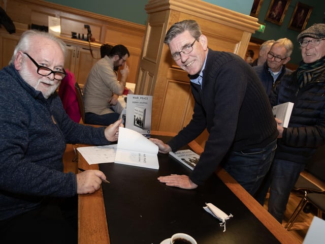 SDLP Councillor John Boyle getting a copy signed on Thursday night. At back right is Jude Collins, Media Commentator.