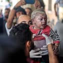 KHAN YOUNIS, GAZA - OCTOBER 16: Palestinian children injured during Israeli raids in the southern Gaza Strip arrive on October 16, 2023 in Khan Yunis, Gaza. (Photo by Ahmad Hasaballah/Getty Images)