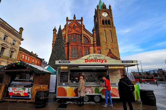 People getting hot food at Christmas Market in Guildhall Square on Friday afternoon. Photo: George Sweeney. DER2250GS – 58