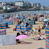 Crowds enjoy Portrush beach along the Causeway Coast and Glens route. Pic Colm Lenaghan/  Pacemaker