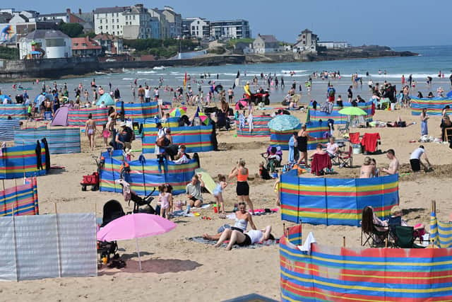 Crowds enjoy Portrush beach along the Causeway Coast and Glens route. Pic Colm Lenaghan/  Pacemaker
