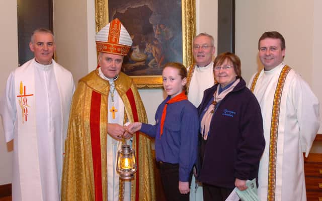 2007: The Most Reverend Dr. Seamus Hegarty, Bishop of Derry, with members of St Eugene's Scouts who brought the Peace Light of Bethlehem to the carol service held in the church. Included, from left, Father Michael Canny, Beth Doherty, Father David O'Kane, Celine Taylor, beavers leader, and Father Gary Wade. (2112PG19)