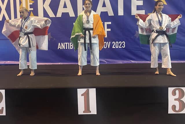 WORLD CHAMPION . . . Erin McCole on the podium at the WUKF European Karate Championship after winning the gold medal in Senior Kata.jpg