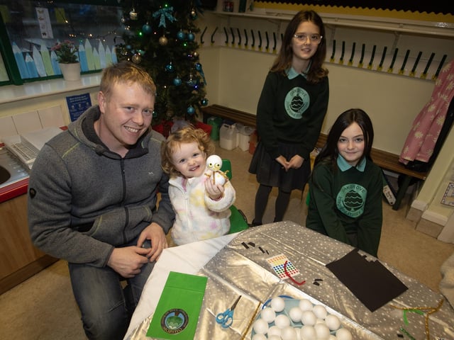 Dad Christopher Ramsey and daughter Abilgail showing off their model at the Oakgrove Integrated Open Day on Thursday. Included are P7 pupils Katie and Eva. : .
