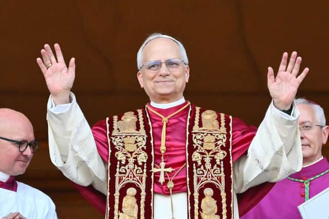 Newly elected Pope Leo XIV, Robert Prevost arrives on the main central loggia balcony of the St Peter's Basilica for the first time, after the cardinals ended the conclave, in The Vatican, on May 8, 2025. Robert Francis Prevost was on Thursday elected the first pope from the United States, the Vatican announced. A moderate who was close to Pope Francis and spent years as a missionary in Peru, he becomes the Catholic Church's 267th pontiff, taking the papal name Leo XIV. (Photo by Alberto PIZZOLI / AFP) (Photo by ALBERTO PIZZOLI/AFP via Getty Images)