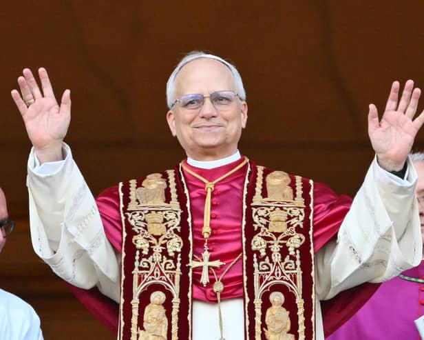 Newly elected Pope Leo XIV, Robert Prevost arrives on the main central loggia balcony of the St Peter's Basilica for the first time, after the cardinals ended the conclave, in The Vatican, on May 8, 2025. Robert Francis Prevost was on Thursday elected the first pope from the United States, the Vatican announced. A moderate who was close to Pope Francis and spent years as a missionary in Peru, he becomes the Catholic Church's 267th pontiff, taking the papal name Leo XIV. (Photo by Alberto PIZZOLI / AFP) (Photo by ALBERTO PIZZOLI/AFP via Getty Images)