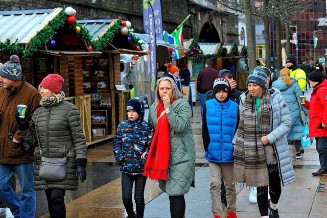 People visiting the Christmas Market in Guildhall Square on Friday afternoon. Photo: George Sweeney. DER2250GS – 68
