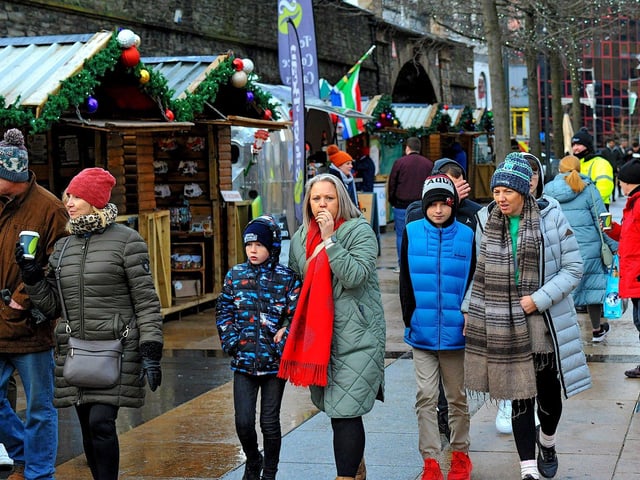 People visiting the Christmas Market in Guildhall Square on Friday afternoon. Photo: George Sweeney. DER2250GS – 68