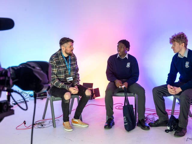 Dolapo Julius and Armandus Papsgs find out about media courses at NWRC from lecturer Michael Timoney. (pic Martin McKeown).