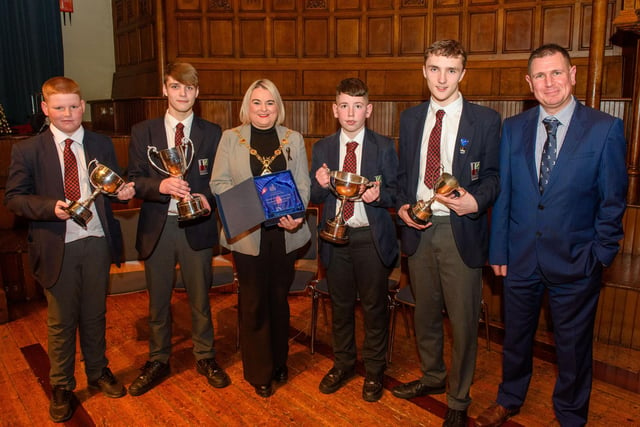 The Mayor Councillor Sandra Duffy welcomed pupils from Lisneal College to the Guildhall as she recognised the hugely successful cricket teams who claimed four trophies last season including the, U15 Ulster Schools Cup,Under 14 Derriaghy Cup, U13 Slemish Cup, U12 Wesley Ferris Cup. Pictured with Head Coach Chris Wilson are team captains,  Charlie Neely U13, Jack McIvor U14, Adam Allen U12, and Charlie Downey U15. Picture Martin McKeown. 26.01.23:.
