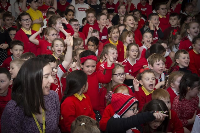 Pupils and staff of Steelstown Primary School cheer the arrival of Derry City trio Shane and Patrick McEleney and Michael Duffy on Tuesday.