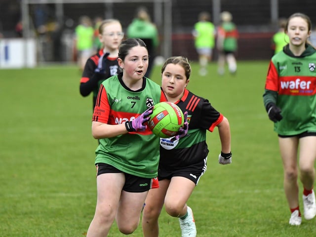 Young footballers from Doire Trasna and Slaughtmanus Under 12 teams play at half-time at the Derry Junior Football Championship Final held in Celtic Park on Sunday afternoon. Photo: George Sweeney
